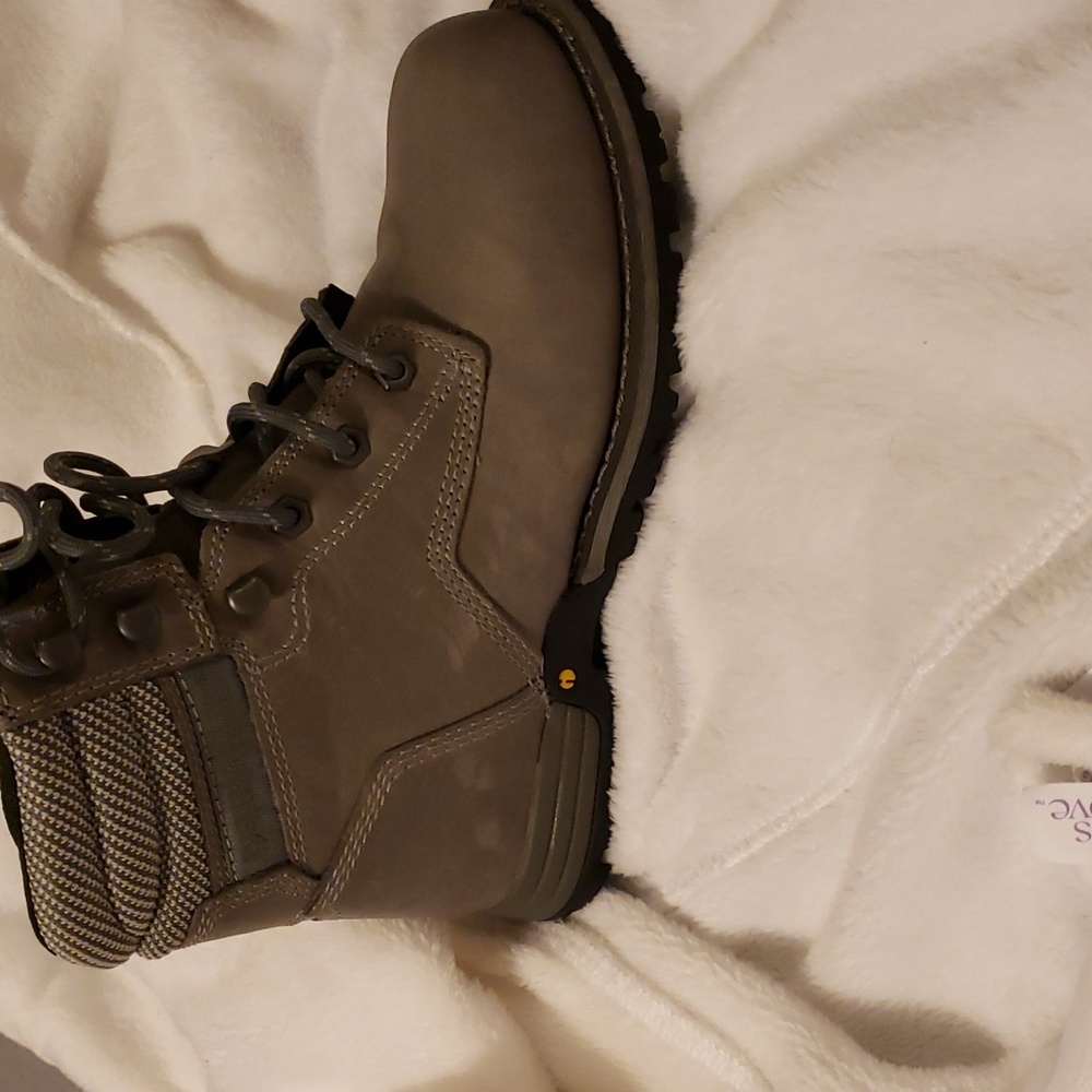 CAT steel toe boots. They are gray on the outside with yellow inside. Women 7.5